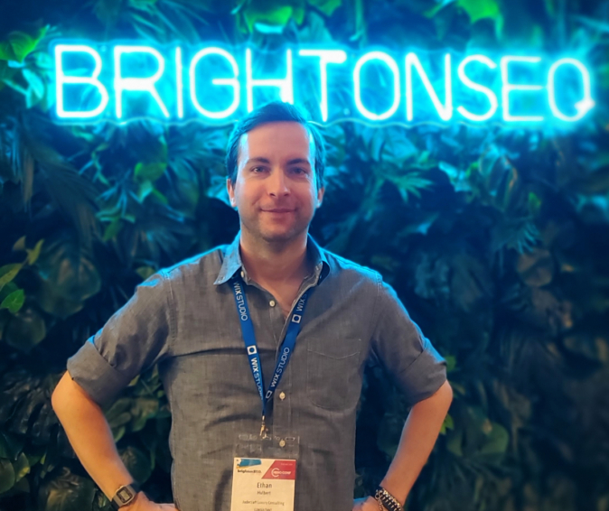 Here I am, Ethan Hulbert, in front of the neon BrightonSEO sign and jungle display, San Diego 2024 Day 2!