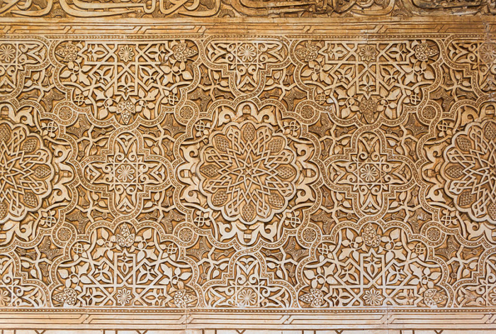 A dense Islamic or Arabesque pattern carved into the Alhabmra.